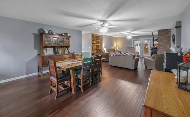 dining space with ceiling fan, dark hardwood / wood-style floors, and a textured ceiling