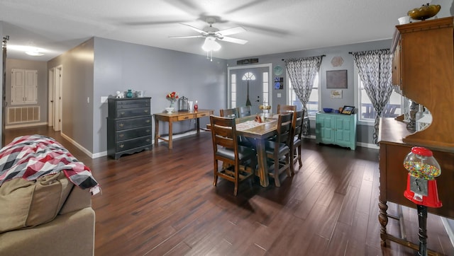 dining area featuring dark wood-type flooring and ceiling fan