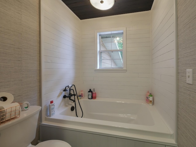 bathroom featuring a tub and toilet