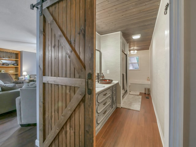 bathroom with hardwood / wood-style flooring, vanity, and wooden ceiling