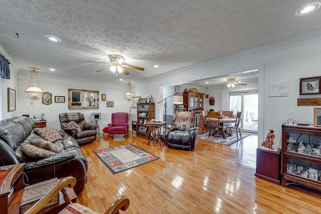 living room with crown molding, hardwood / wood-style flooring, and ceiling fan