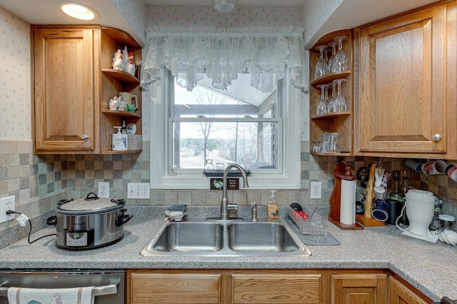 kitchen with tasteful backsplash, sink, and dishwasher