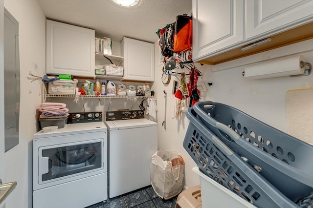 laundry room with washer and clothes dryer, cabinets, and a textured ceiling