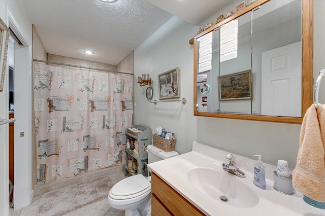 bathroom with vanity, curtained shower, a textured ceiling, and toilet