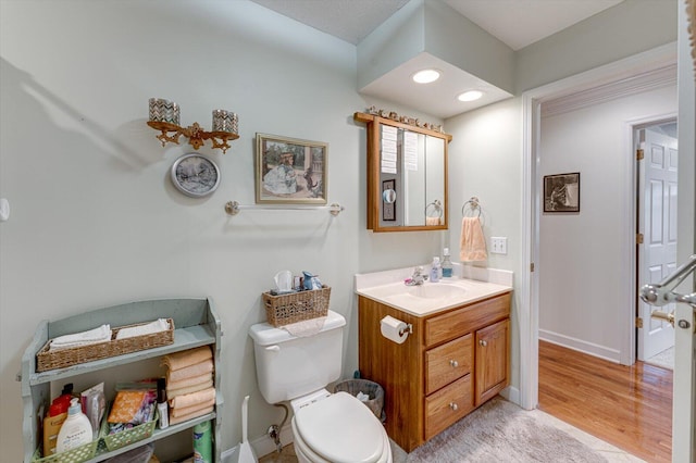 bathroom featuring hardwood / wood-style flooring, vanity, and toilet