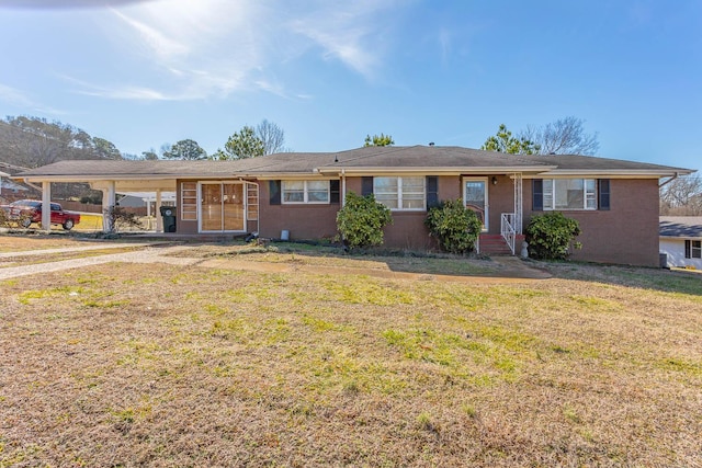 ranch-style house featuring a front lawn and a carport