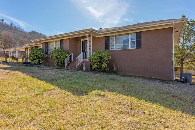 ranch-style house with central AC and a front lawn