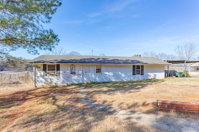 back of property featuring a yard