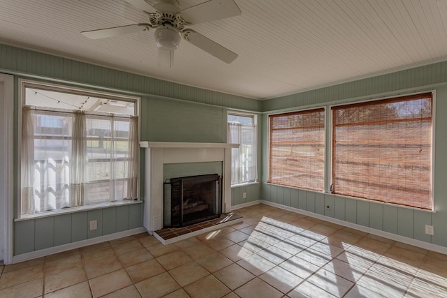 unfurnished living room featuring light tile patterned floors and ceiling fan