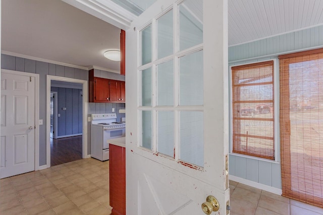 kitchen with crown molding, white range with electric stovetop, and wood walls