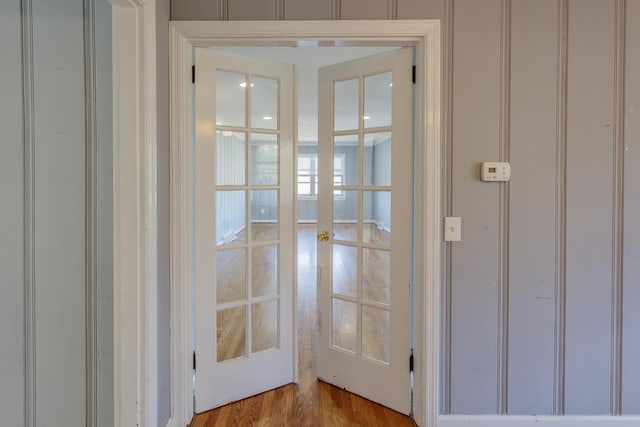 entryway with light hardwood / wood-style floors and french doors