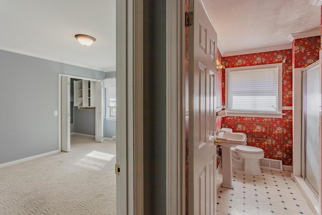 bathroom with ornamental molding and toilet