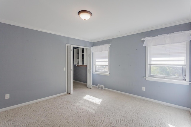 carpeted empty room with ornamental molding