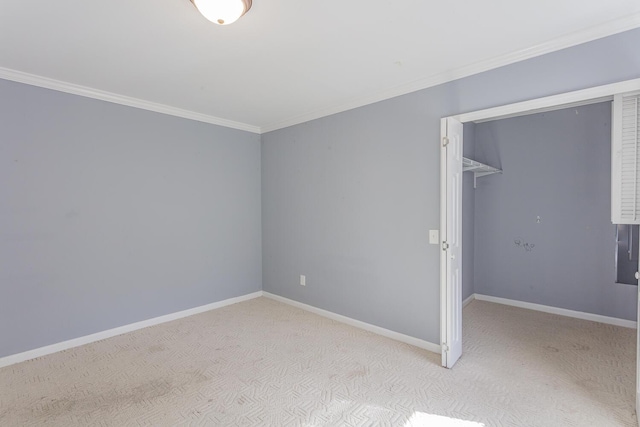 spare room with crown molding and light carpet