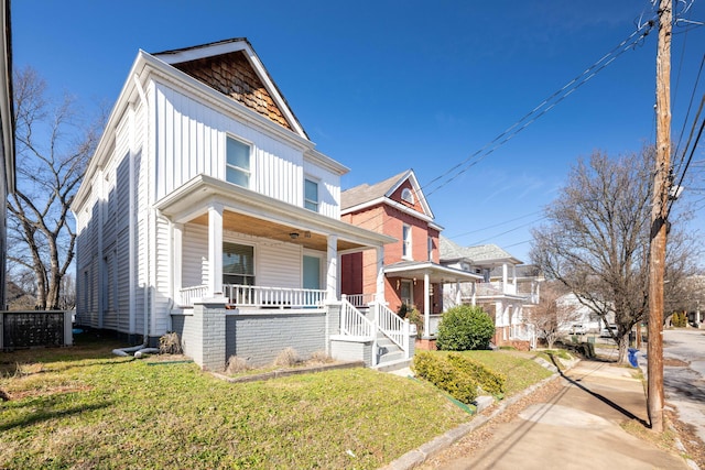 view of front of home featuring covered porch and a front yard