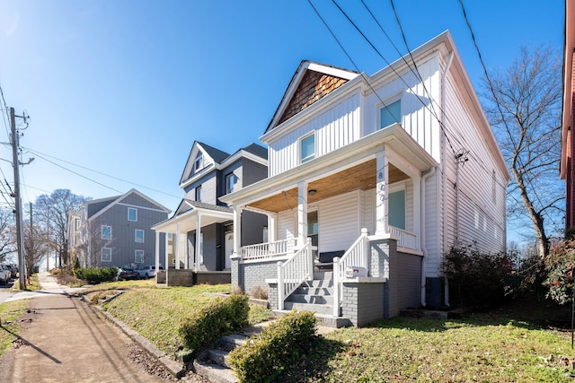 view of front of house with a front yard and covered porch