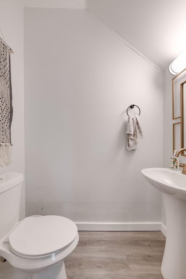 bathroom featuring wood-type flooring, sink, and toilet