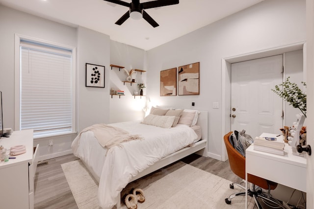 bedroom with light hardwood / wood-style flooring and ceiling fan