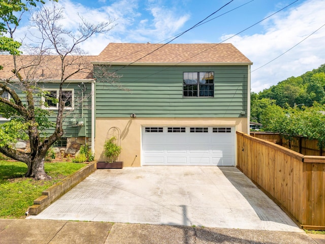 4220 Saint Elmo Ave, Chattanooga, TN 37409 - view of property exterior featuring a garage, a shingled roof, concrete driveway, and stucco siding