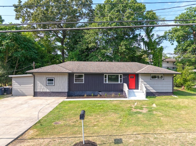 ranch-style home with a garage and a front yard