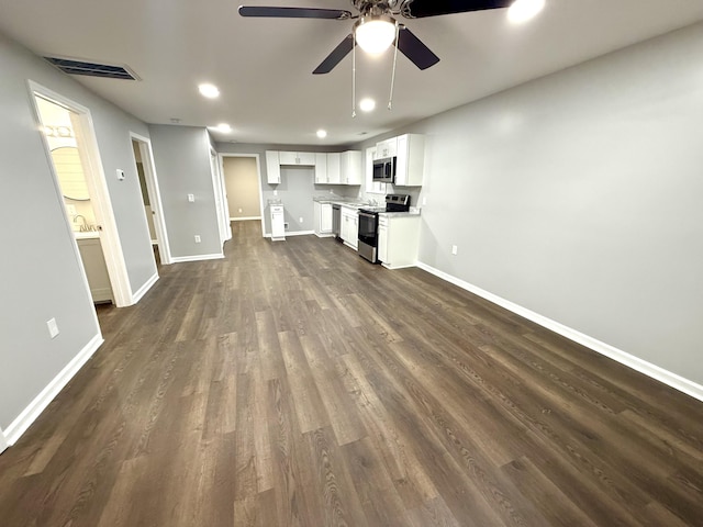 unfurnished living room with dark hardwood / wood-style floors and ceiling fan