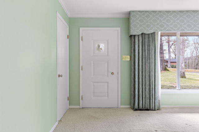 carpeted foyer featuring ornamental molding