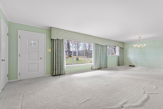 interior space with carpet floors, ornamental molding, and a chandelier