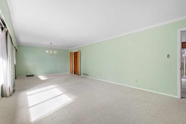 unfurnished room featuring crown molding, carpet floors, and a notable chandelier