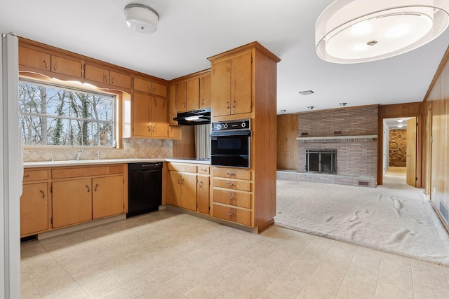 kitchen with sink, backsplash, black appliances, light carpet, and a brick fireplace