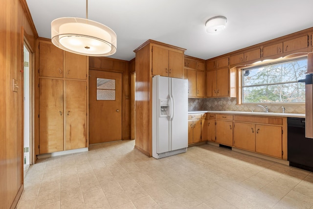 kitchen with dishwasher, sink, decorative backsplash, hanging light fixtures, and white refrigerator with ice dispenser