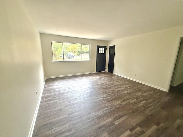 spare room with dark wood-type flooring