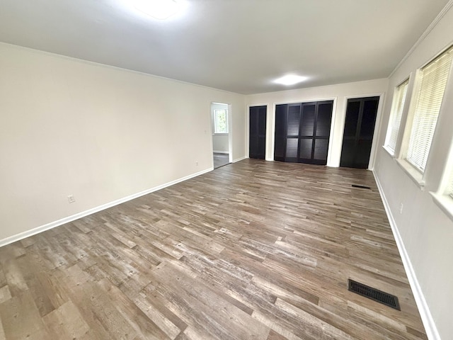 interior space featuring multiple closets and hardwood / wood-style floors