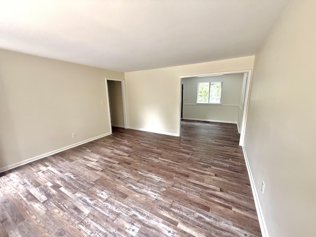 empty room featuring dark wood-type flooring