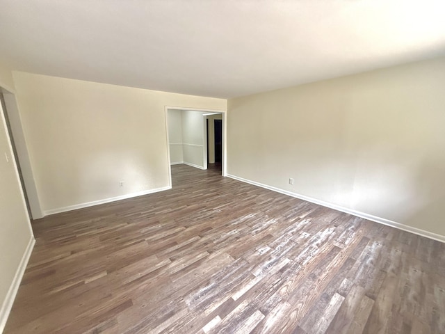 unfurnished room featuring dark hardwood / wood-style floors