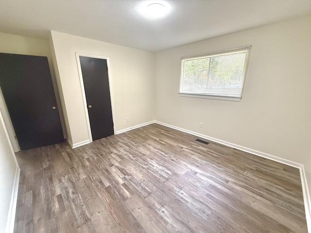 unfurnished bedroom featuring hardwood / wood-style flooring