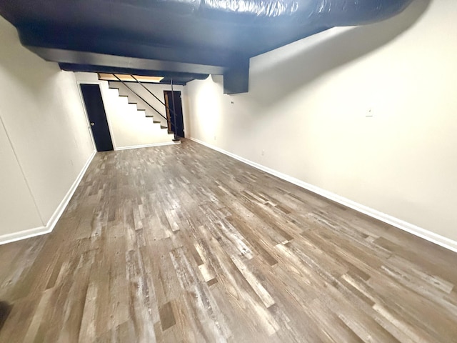 basement with hardwood / wood-style flooring