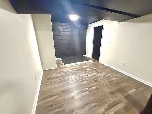 basement with hardwood / wood-style floors