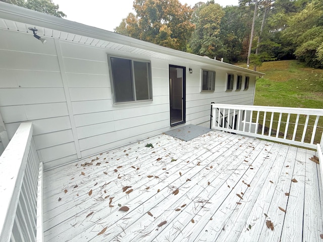 wooden deck featuring a lawn