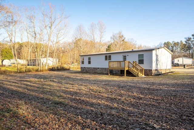 back of house featuring a wooden deck