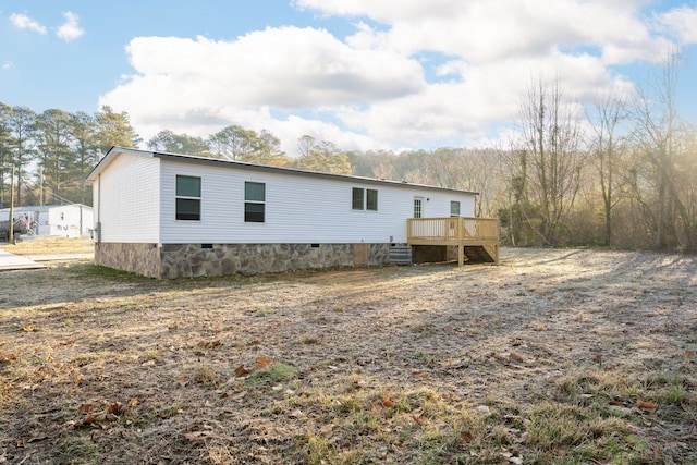 back of house with a deck