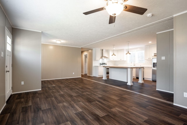 unfurnished living room with ornamental molding, dark wood-type flooring, and a textured ceiling