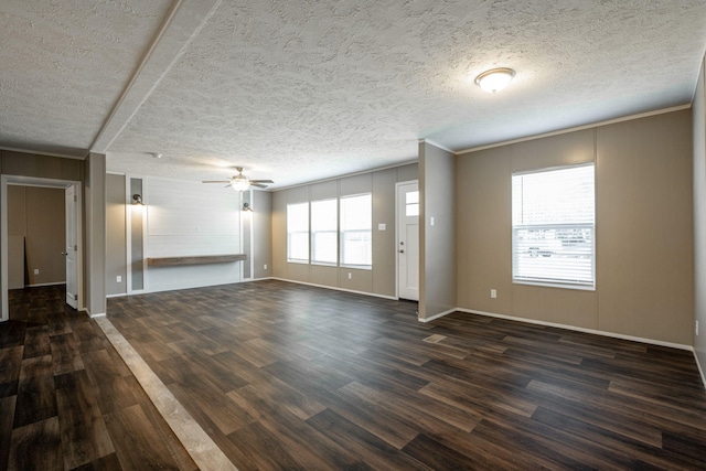 unfurnished living room featuring a textured ceiling, dark wood-type flooring, ornamental molding, and ceiling fan