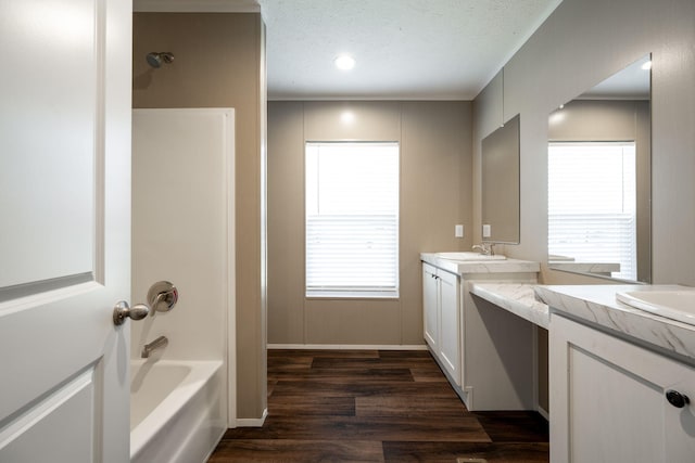 bathroom featuring vanity, hardwood / wood-style floors, a textured ceiling, and a wealth of natural light