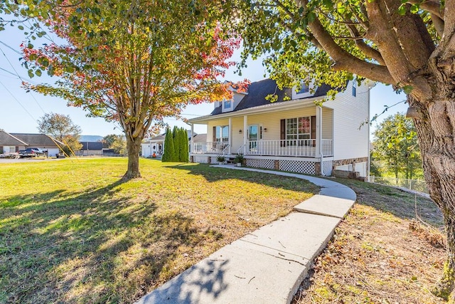 view of front of house featuring covered porch and a front lawn