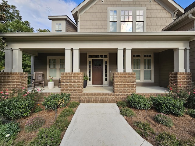 view of exterior entry featuring a porch