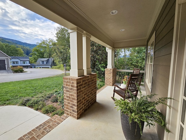 view of patio featuring a mountain view and covered porch