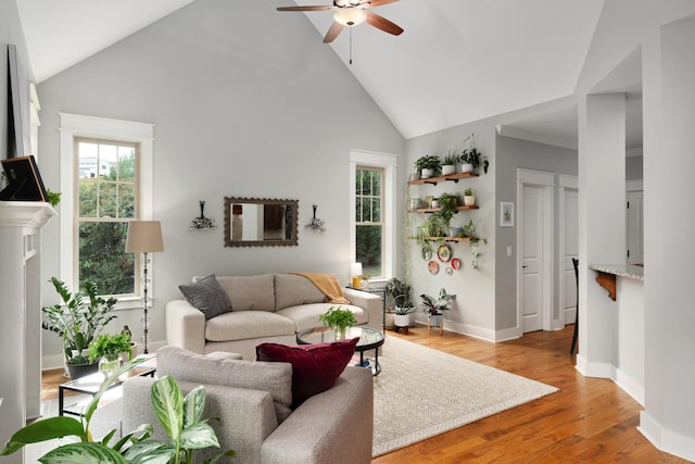 living room with light hardwood / wood-style flooring, high vaulted ceiling, and ceiling fan