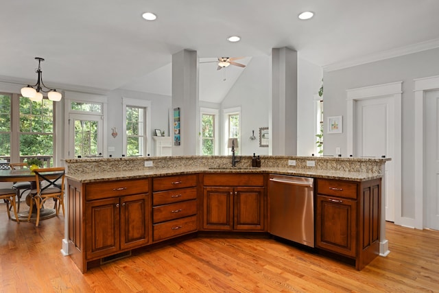 kitchen with a center island with sink, sink, stainless steel dishwasher, and decorative light fixtures