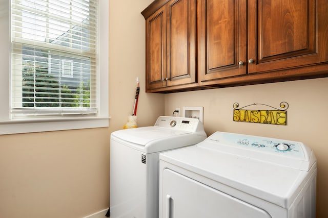 laundry area featuring washing machine and dryer and cabinets