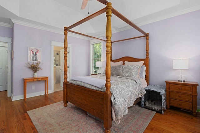 bedroom featuring dark hardwood / wood-style flooring, connected bathroom, crown molding, and ceiling fan